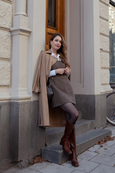 a lady in a brown woolen dress and a trench coat